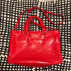Bright red Kate spade crossbody purse.